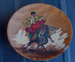 matador painting on wooden plate